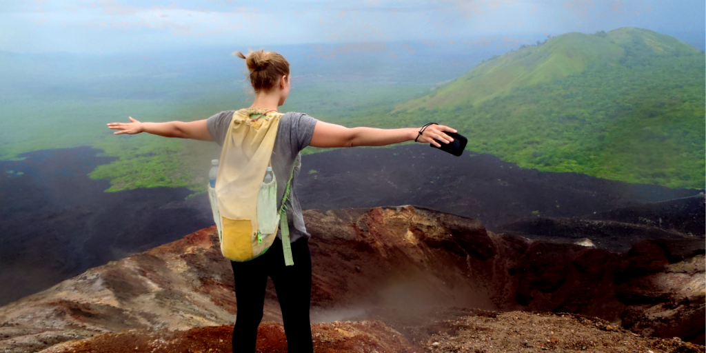 Monica trekking an active volcano in Nicaragua - one of the pros of living abroad.