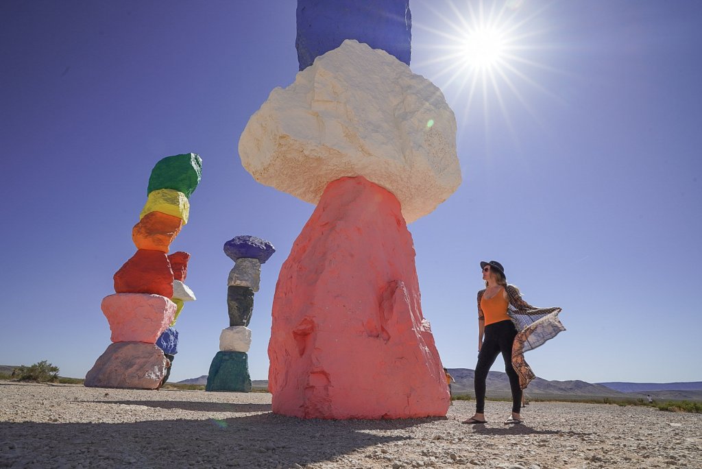 Monica next to the colorful artworks, a must see stop on any California to Arizona Road Trip.