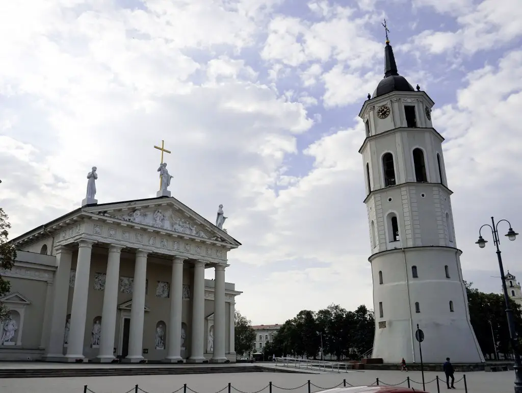 Vilnius Cathedral in front of blue cloudy skies.
