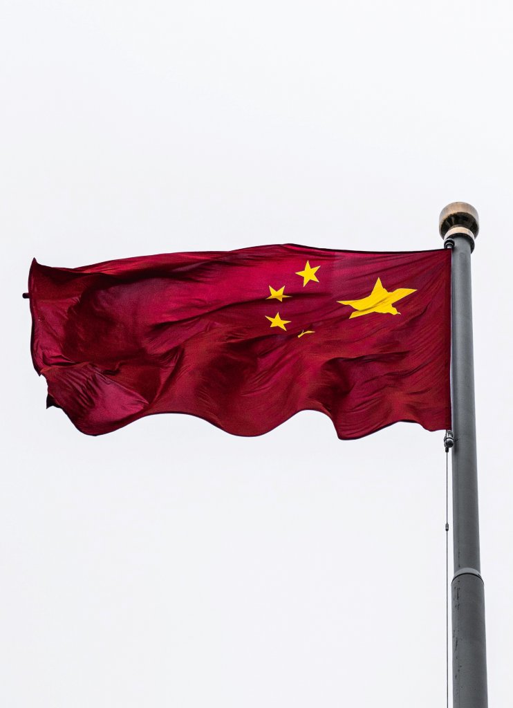 The Chinese flag blowing in the wind.