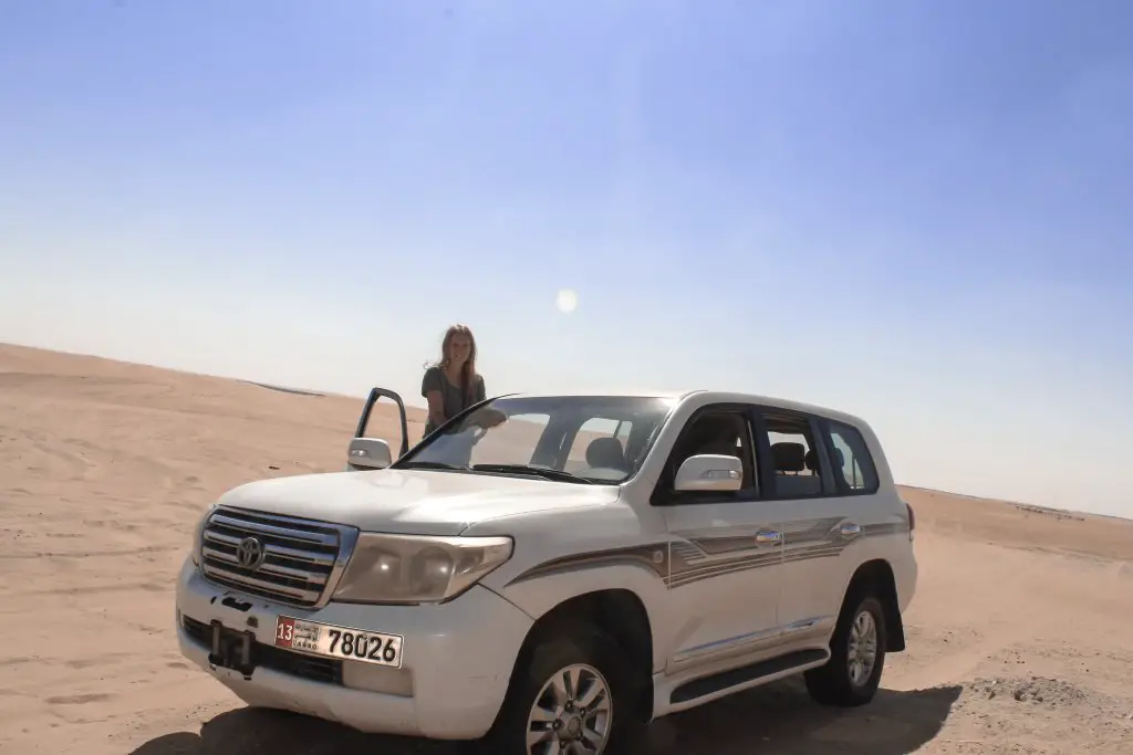 Monica on the 4x4 car ready to drive into Liwa Desert for safari