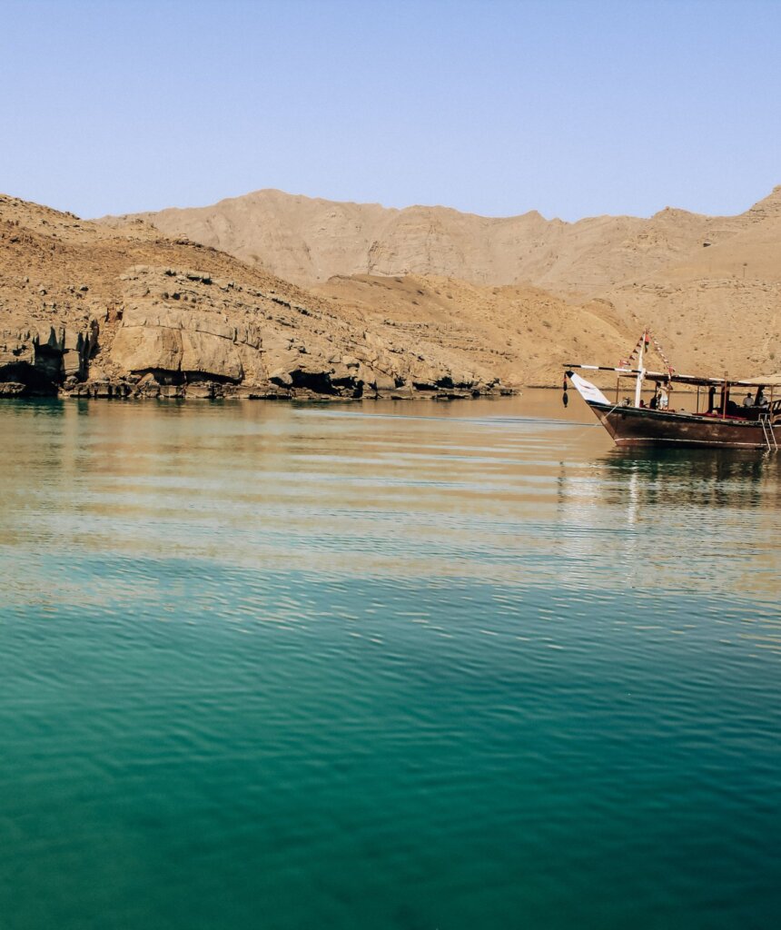 The bright blue waters of the Musandam Peninsula - one of the best places to visit in Oman.