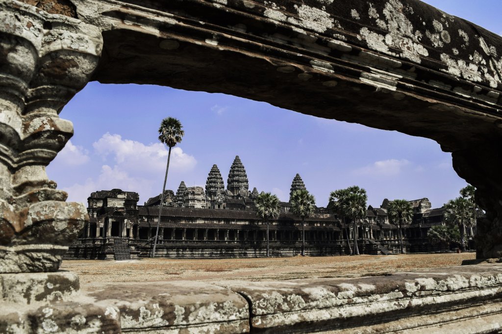 A photo of the Angkor Wat Ruins with a blue sky.