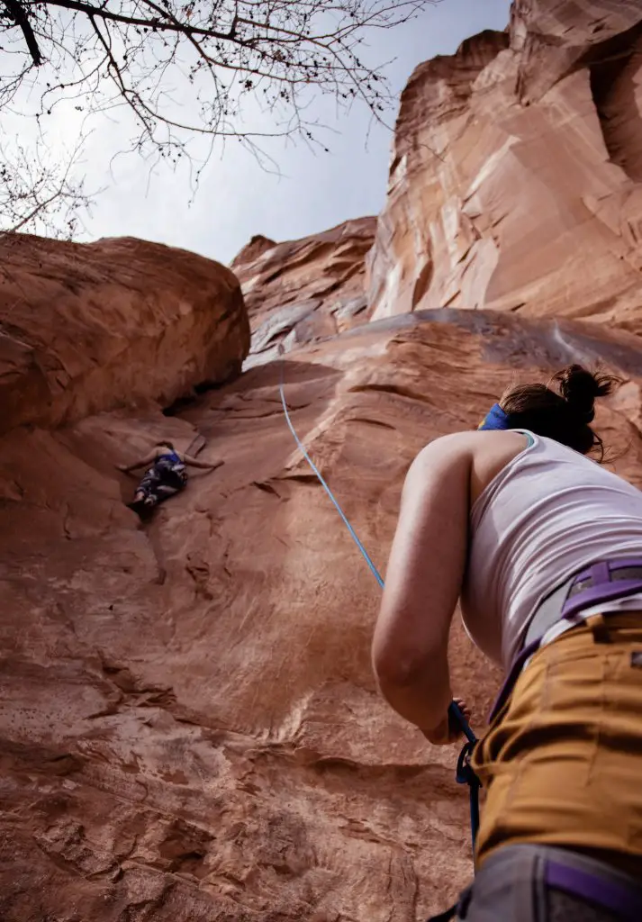 Try rock climbing as one of your simple bucket list ideas - two girls on red rock.
