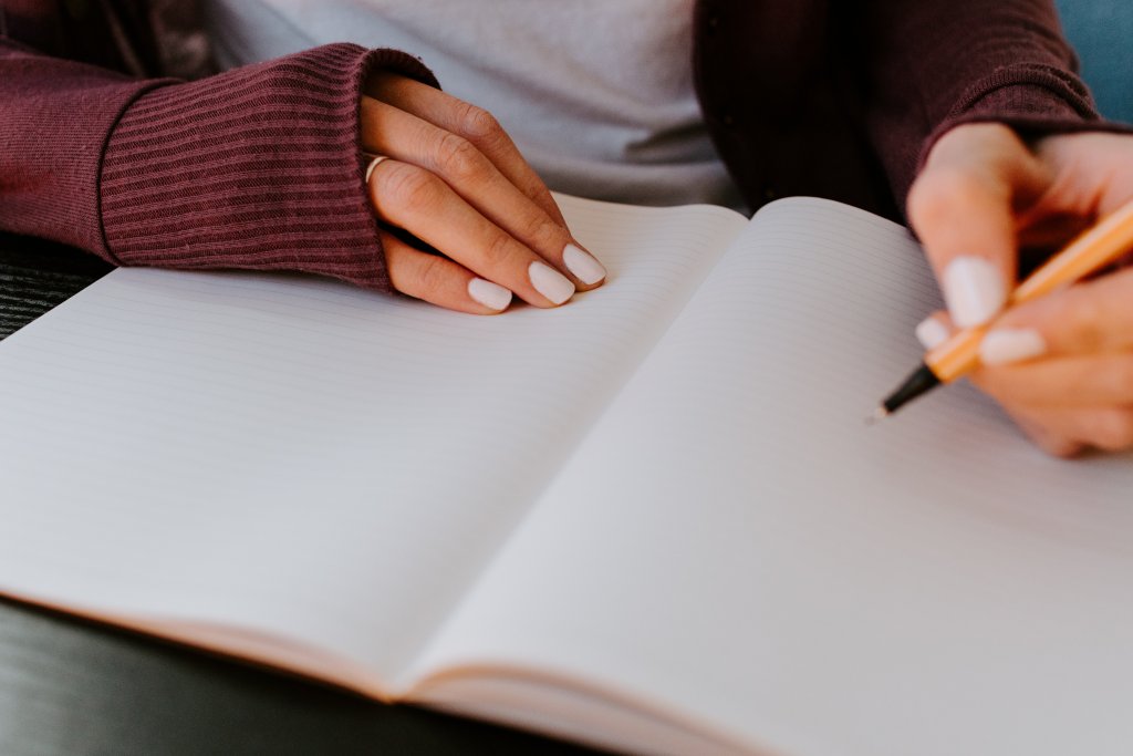 Girl writing a list to make a change in her life; a simple bucket list ideas necessity.