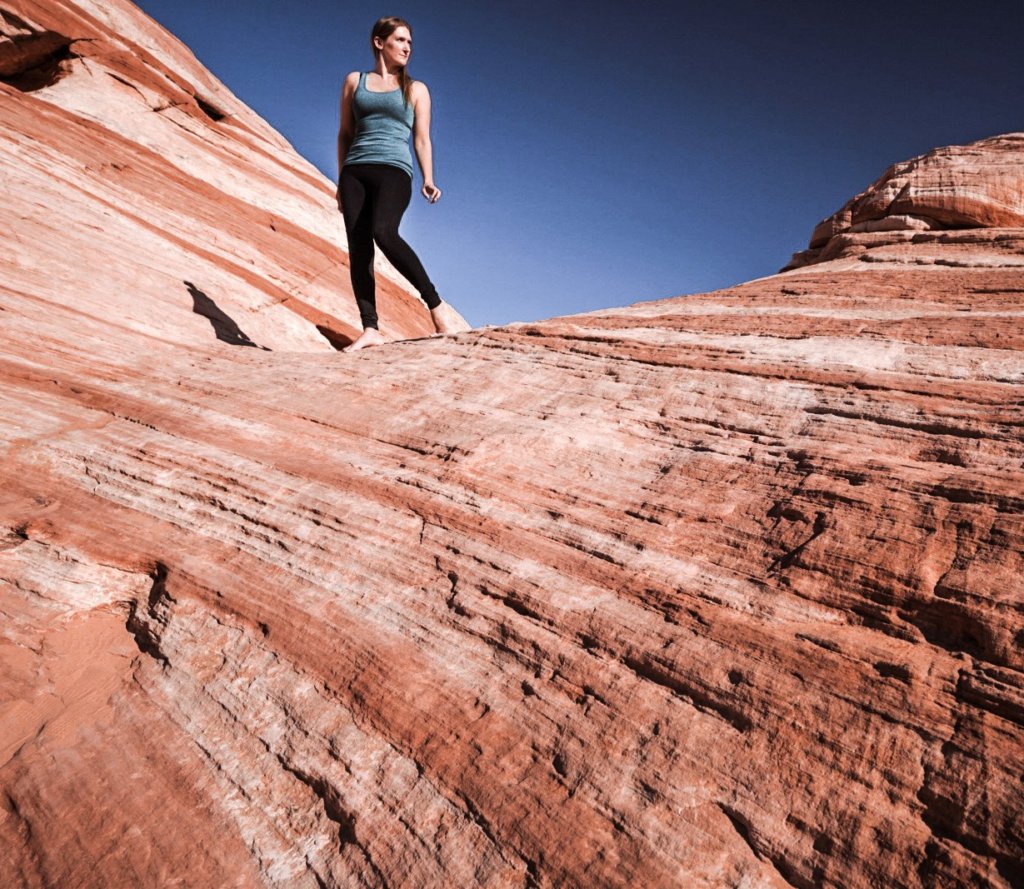 Monica exploring the Valley of Fire on red and white rocks.