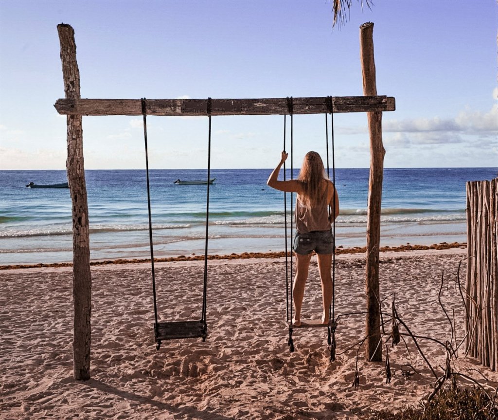 Monica on a swing on Paradise Beach - one of the best Things to Do in the Yucatan Peninsula.