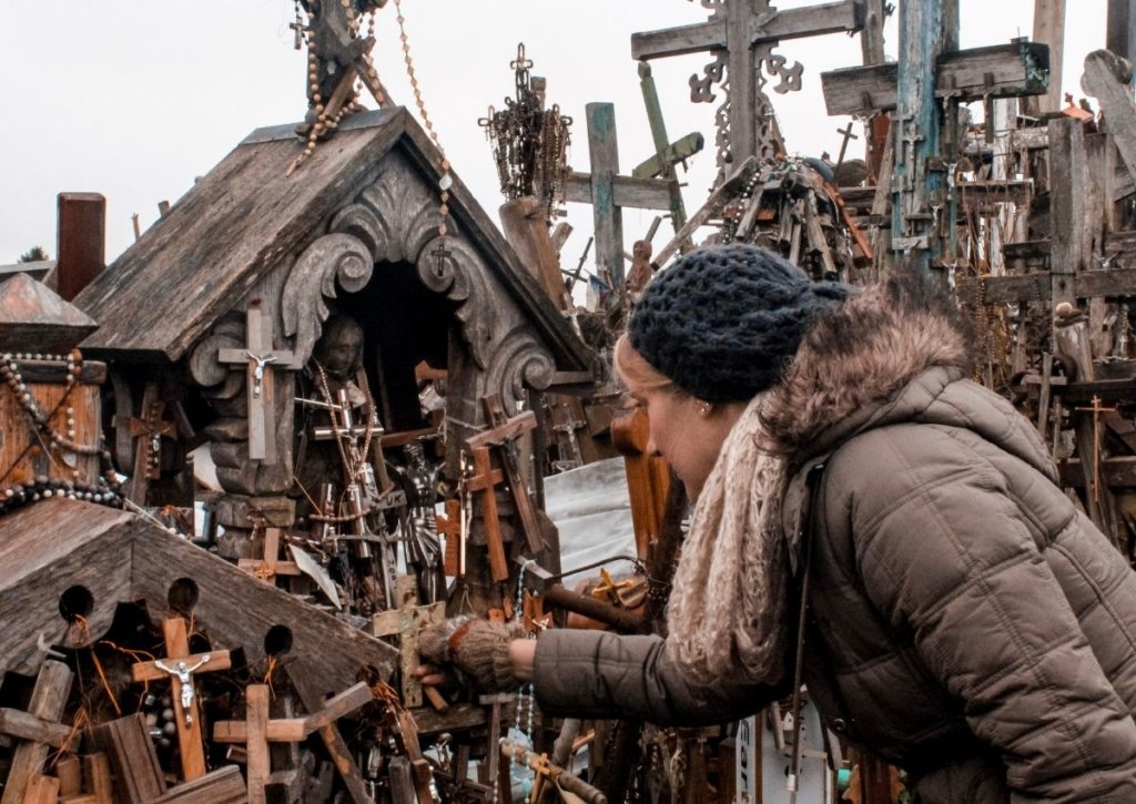 Monica placing a cross at the Hill of Crosses Lithuania.