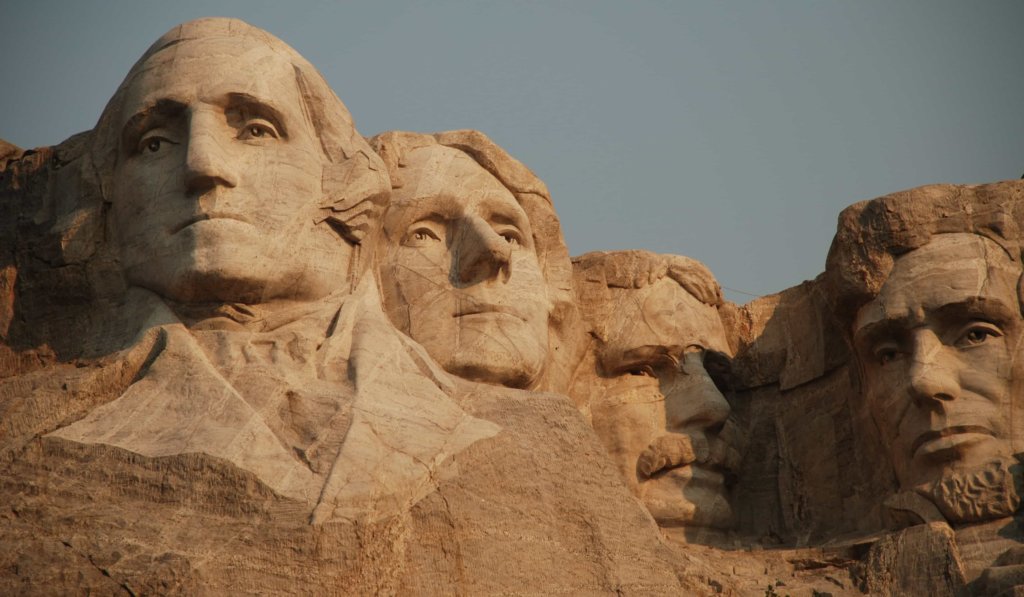 Mount Rushmore against the blue sky.