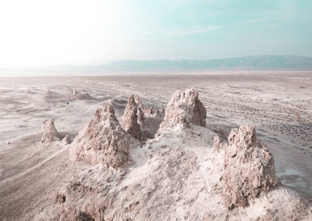 The trona pinnacles in the Mojave Desert,  in front of a sunny sky.