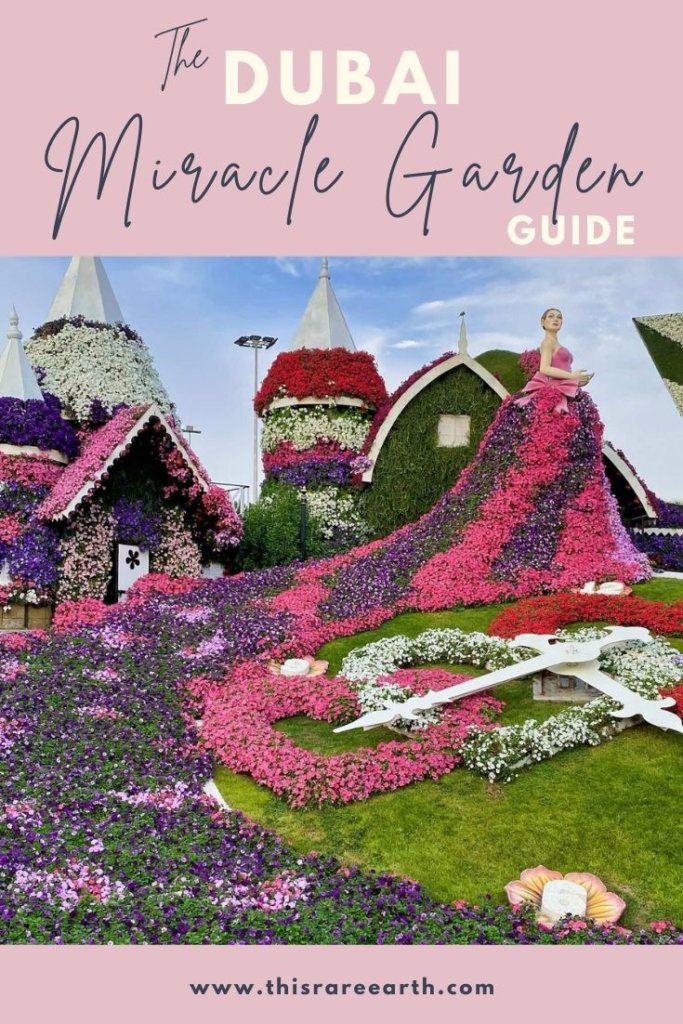 Dubai Miracle Garden Guide Pin with pink, red and white flowers.