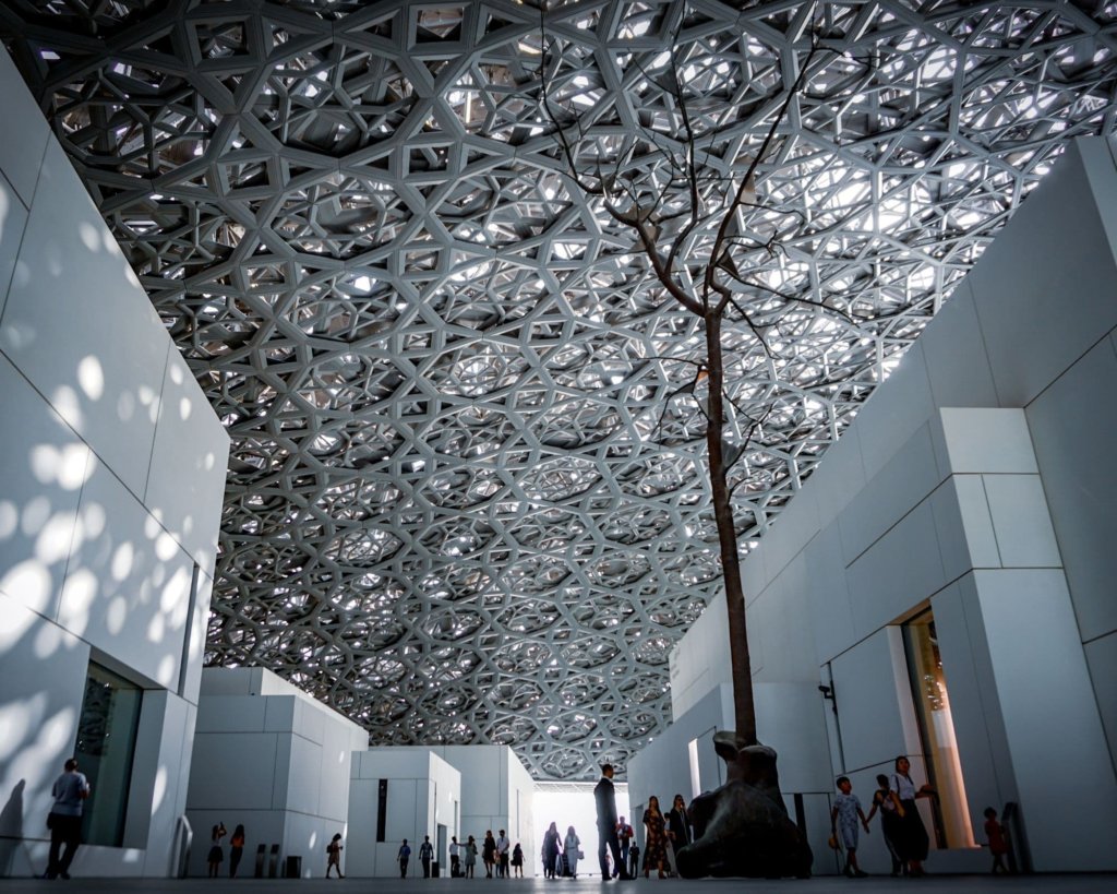 The intricate white architecture at the Louvre Abu Dhabi.