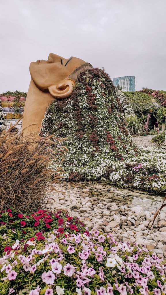 A sculpture featuring flowers in a woman's hair at the Dubai Miracle Garden.