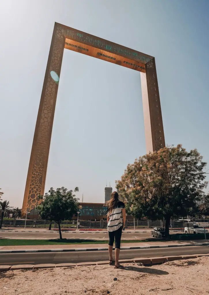 Monica looking up at The Golden Frame in Dubai.