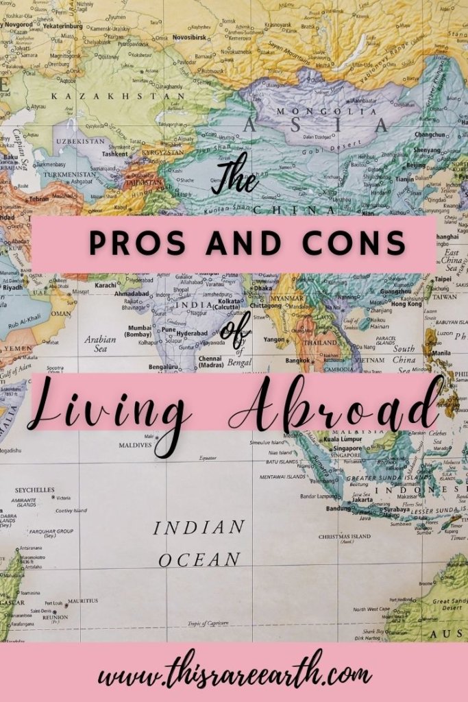 The Pros and Cons of Living Abroad Pin with world map.