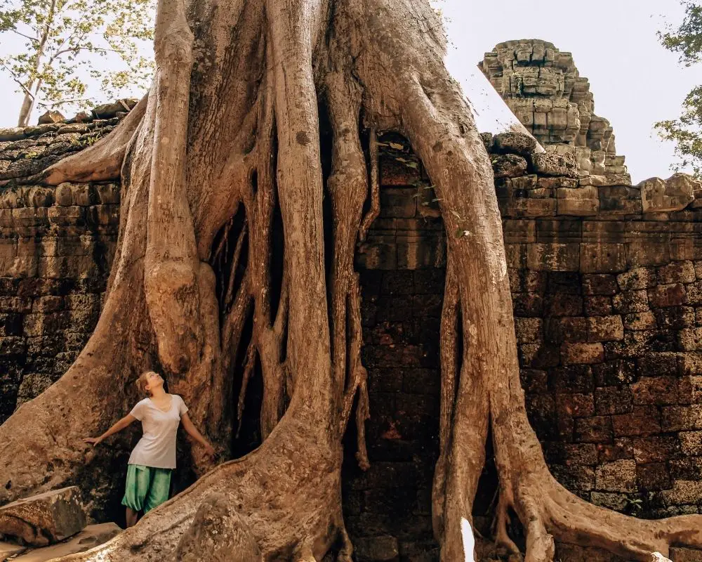 Monica standing solo near the ancient ruins of Cambodia.