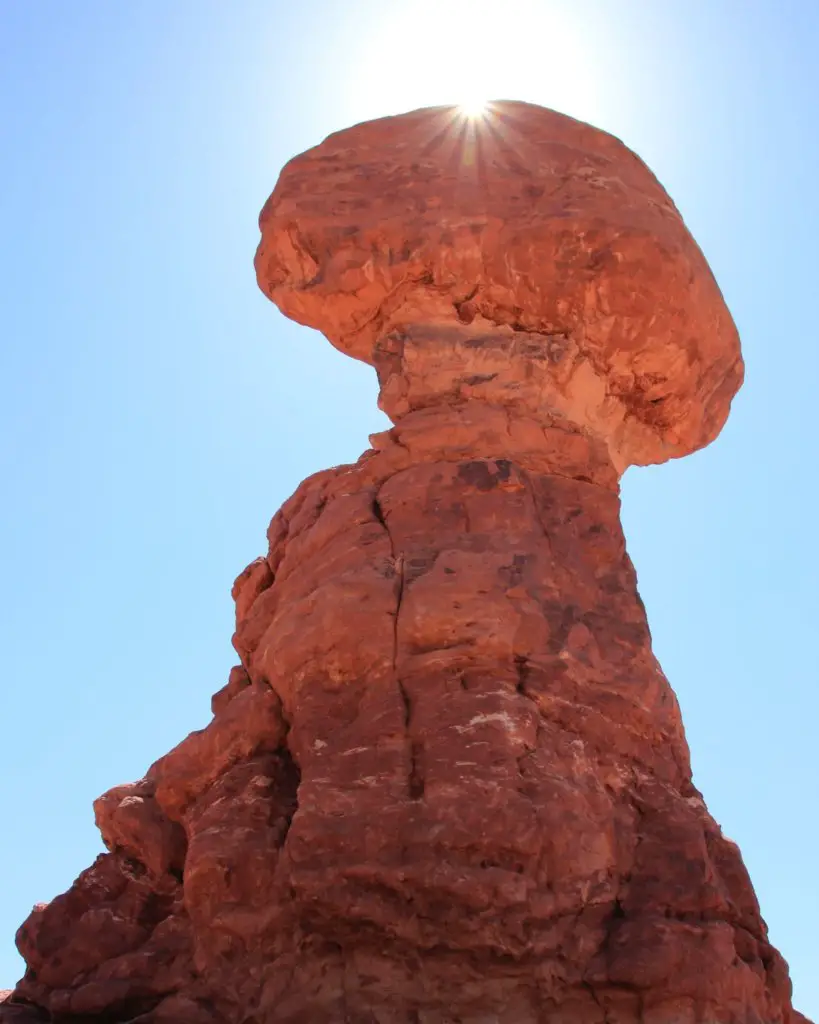 Balanced Rock in front of the bright sunlight, an easy but awesome hike in Arches National Park.