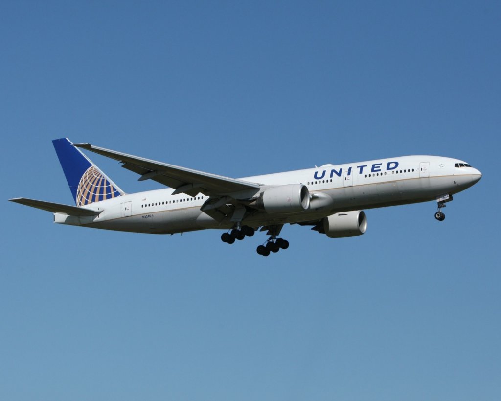 United Airlines flying in blue sky.