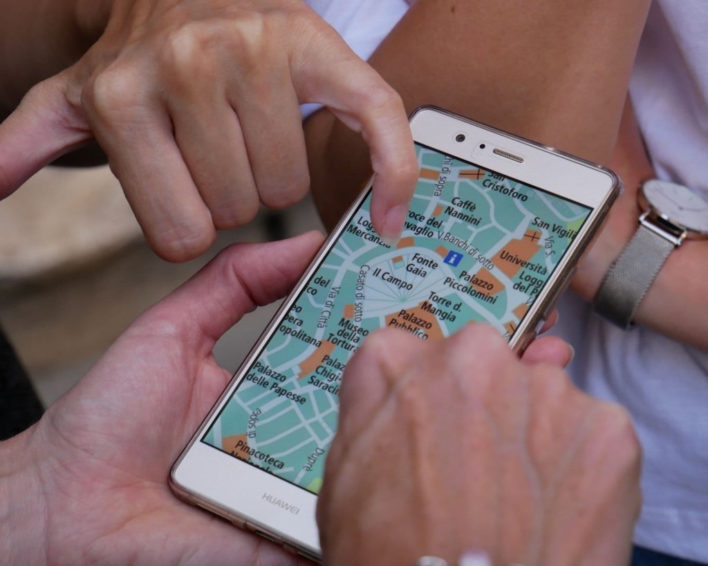 Several people checking the map on Google Maps.