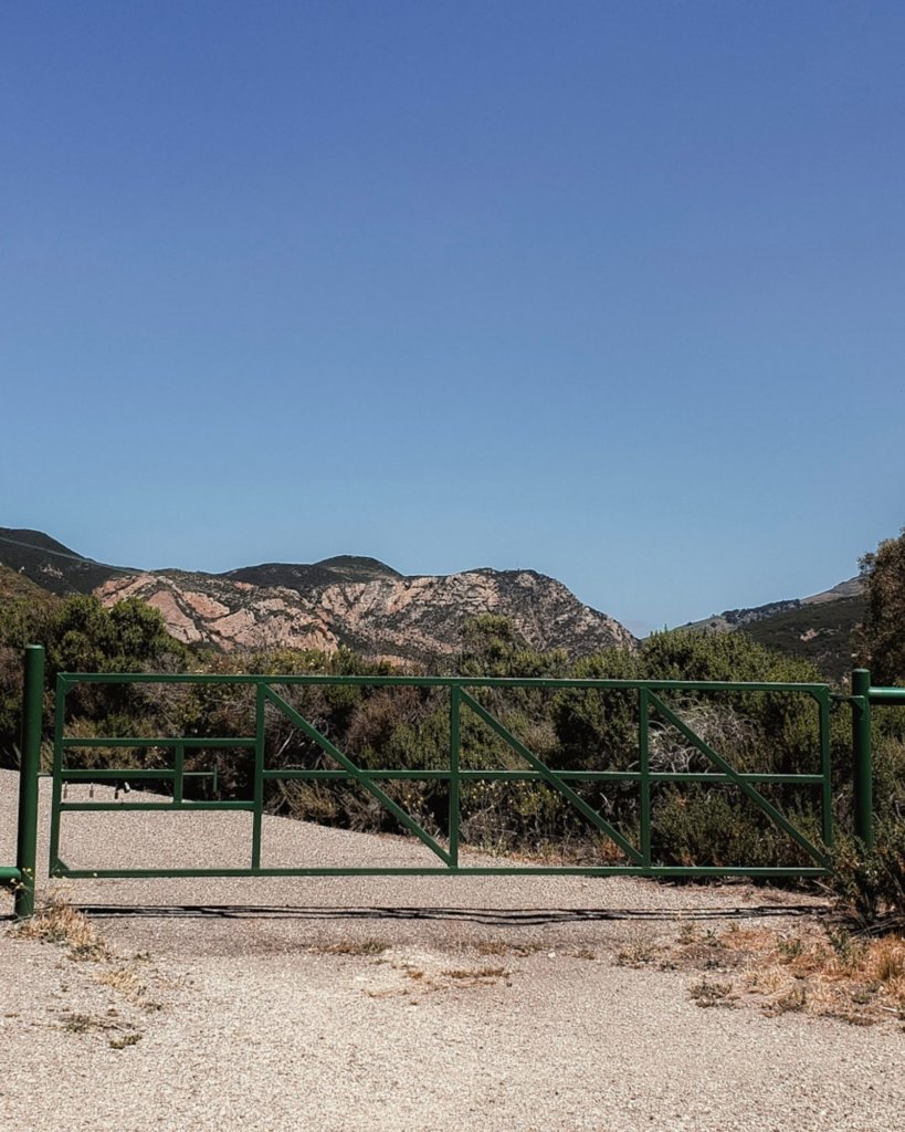 The green gate marking The Gaviota Wind Caves Trail hike near Santa Barbara.