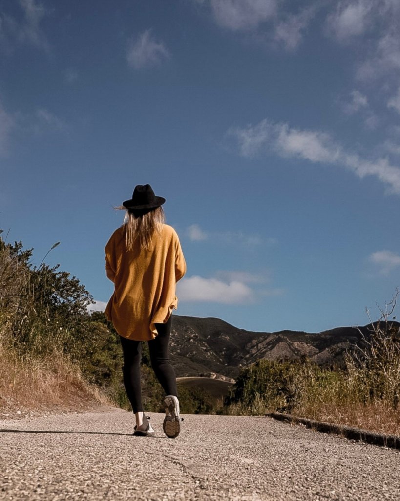 Monica walking the paved path to The Gaviota Wind Caves Trail.