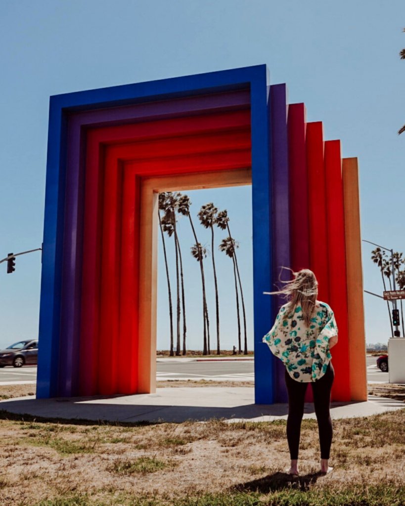 Monica in front of the Chromatic Gate, a must see sight on a day trip to Santa Barbara!