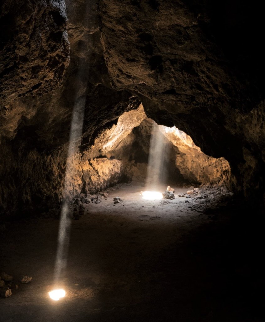 The Mojave National Preserve Lava Tubes with light streaming in through the ceiling.