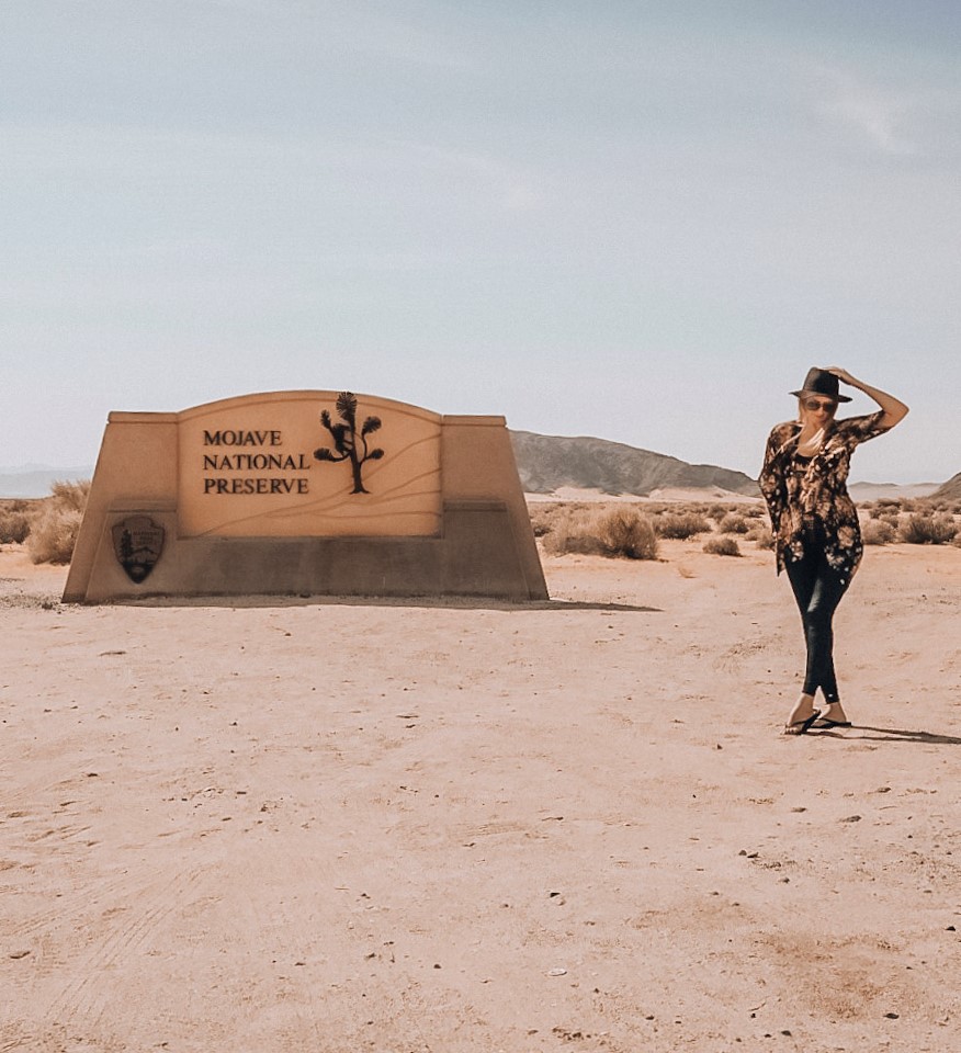 Monica at the Mojave National Preserve entrance sign.