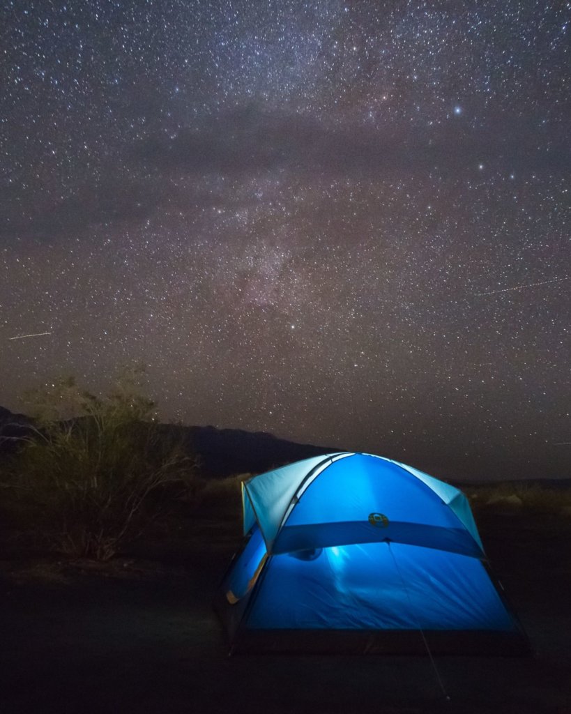 Camping in Death Valley with a bright blue tent.