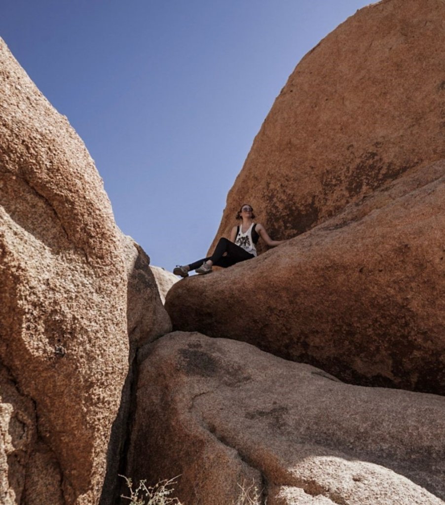 Monica on the rounded rocks seen while visiting Joshua Tree National Park.