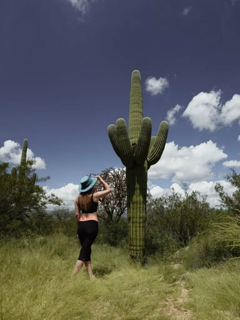 Monica greeting a tall Saguaro cactus.