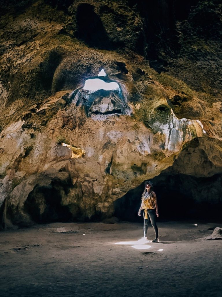 Monica exploring the caves in Aruba - Reasons to Travel Alone This Year. 