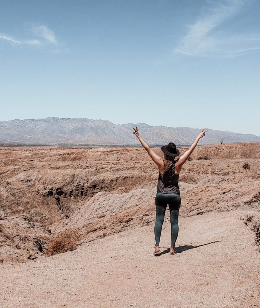 Monica in front of the rugged Anza Borrego mountain, one of the easiest weekend trips from San Diego.