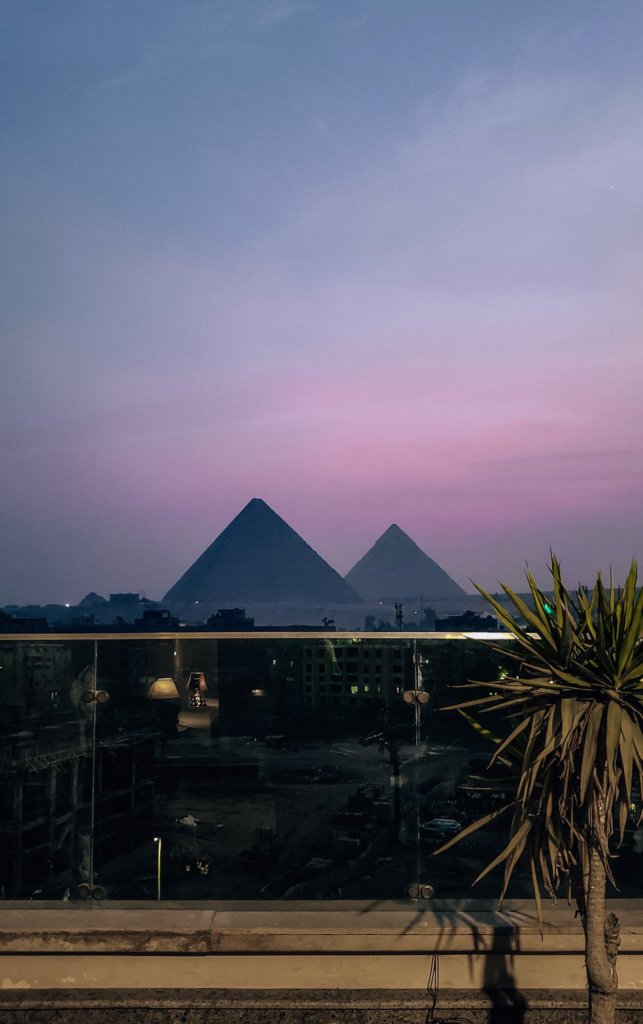 A view of the pyramids at sunset - Solo Female travel in Egypt.