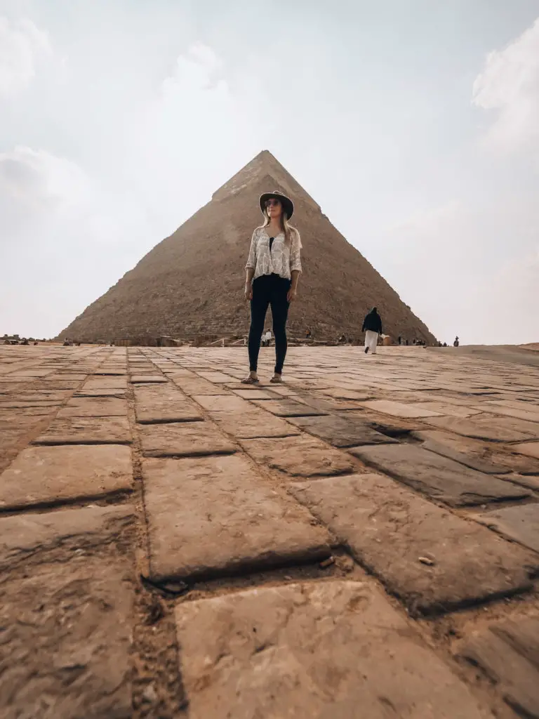 Monica in front of a Pyramid at Giza during Solo Female Travel in Egypt: What It's REALLY Like.