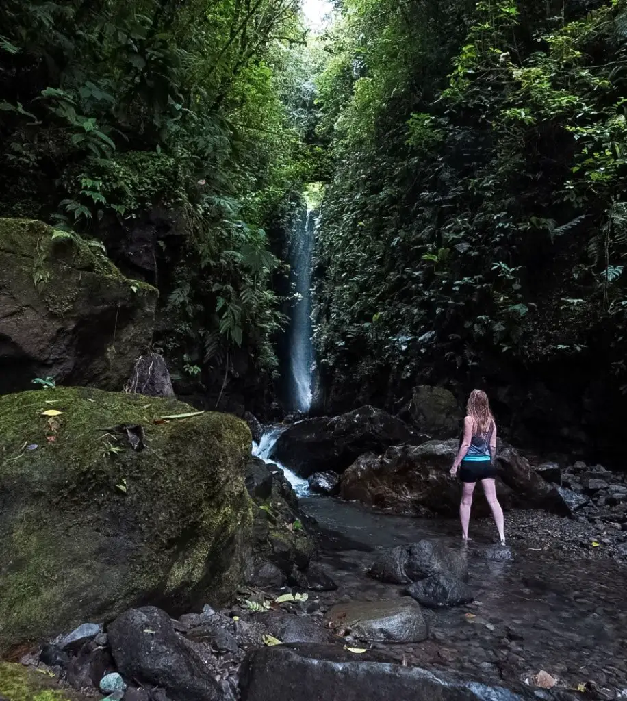 Monica in front of the rushing waterfall Celestine,, one of the best places to visit in Chiriqui, Panama.