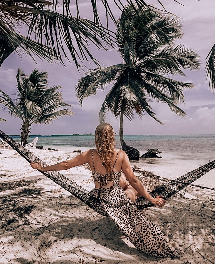 Monica on a hammock, Visiting the San Blas Islands, Panama. The blue water off of Wailidup Island in the distance.