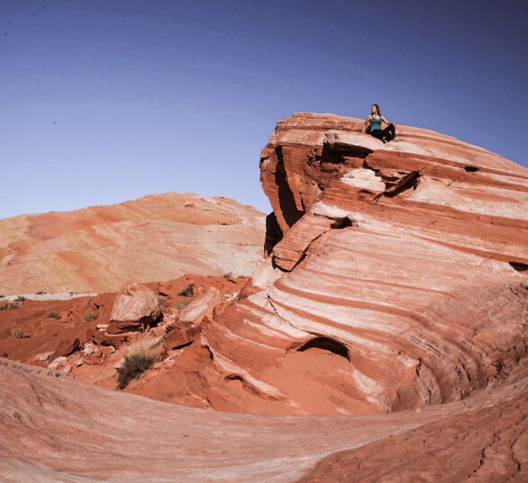 Monica hiking on the orange rocks at Valley of Fire - one of The Best day trips from Palm Springs.