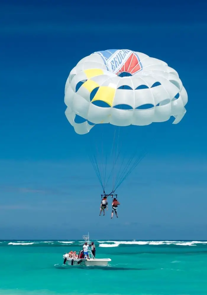 Two tourists parasailing - - one of the best Things to do in Cabo Mexico - Los Cabos.