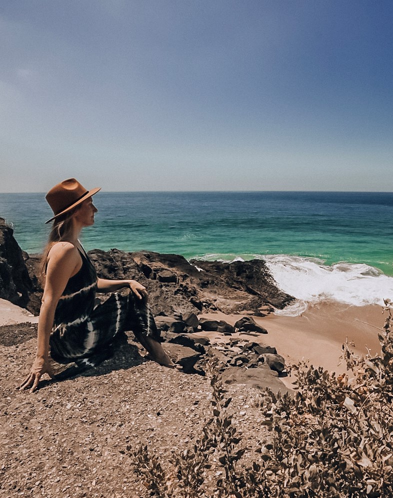 Monica looking out over the blue waters of Malibu, one of The Best Day Trips from Orange County, California.