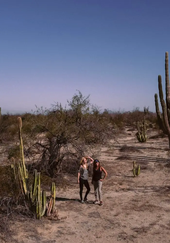 Monica and Cecilia in a cactus covered desert - How to Travel with Friends Tips and Etiquette.