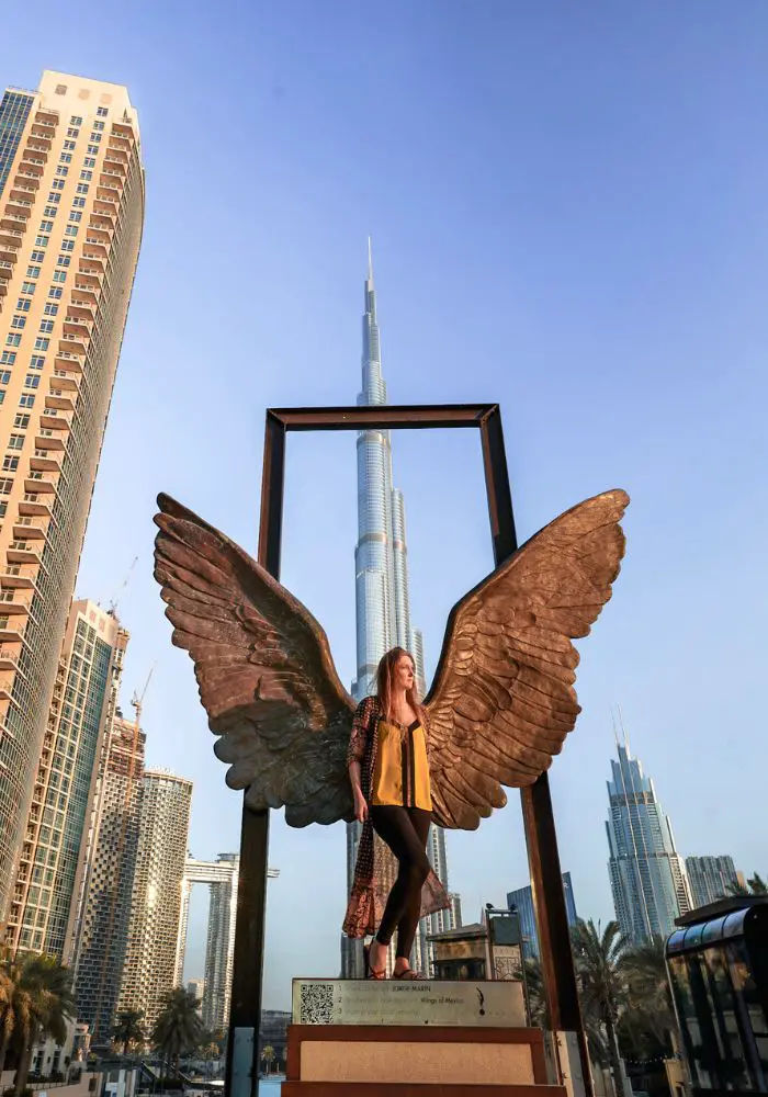 Monica at the Wings of Dubai statue - Is It Safe to Travel to Dubai as a Solo Female?