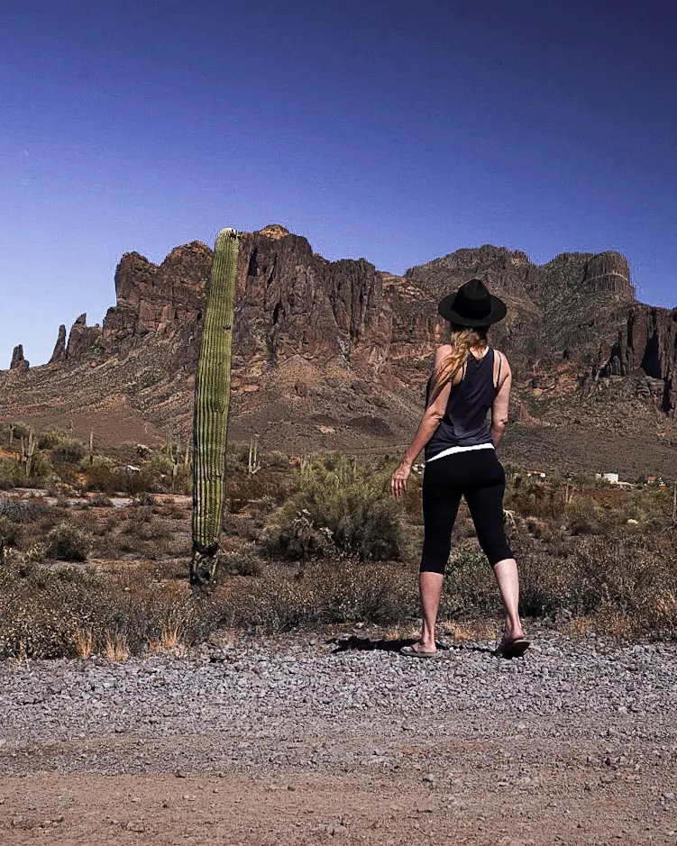 Monica and a tall skinny saguaro cactus near the Superstition Mountains.