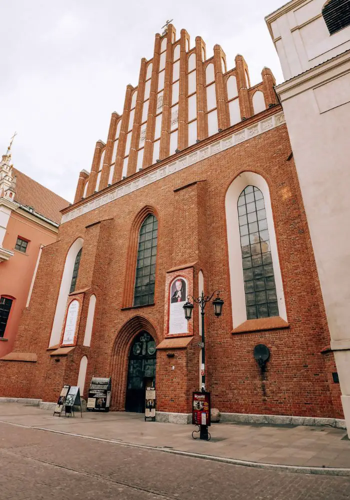 St. John's Cathedral facade of bright red bricks and tall spires, a must see on your one day in Warsaw.
