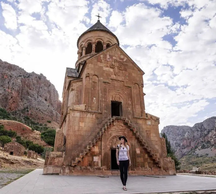 Monica visiting Noravank Monastery, walking in front of Holy Mother of God Church.