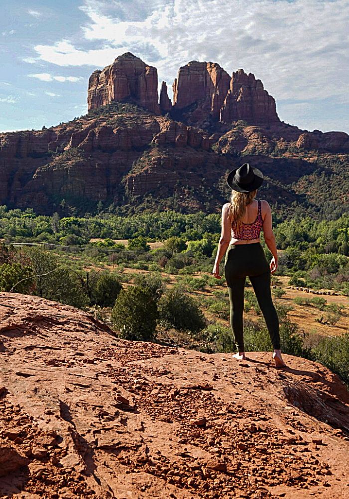 Monica on an easy Sedona hiking trail with orange rocks and sweeping views.