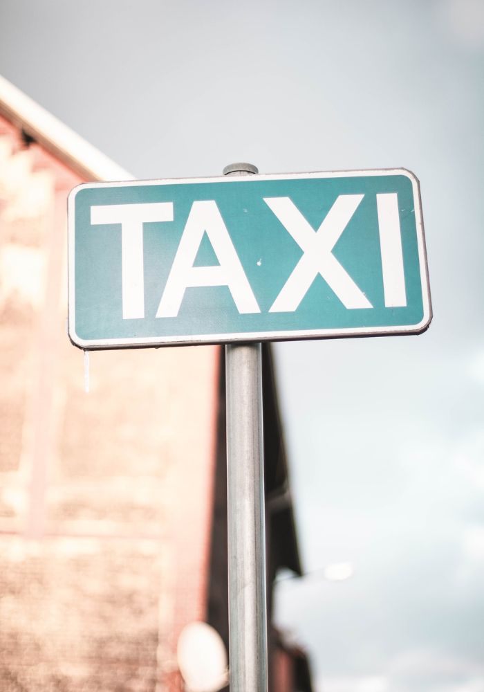 A taxi stand sign - Solo Female Taxi Safety Tips .