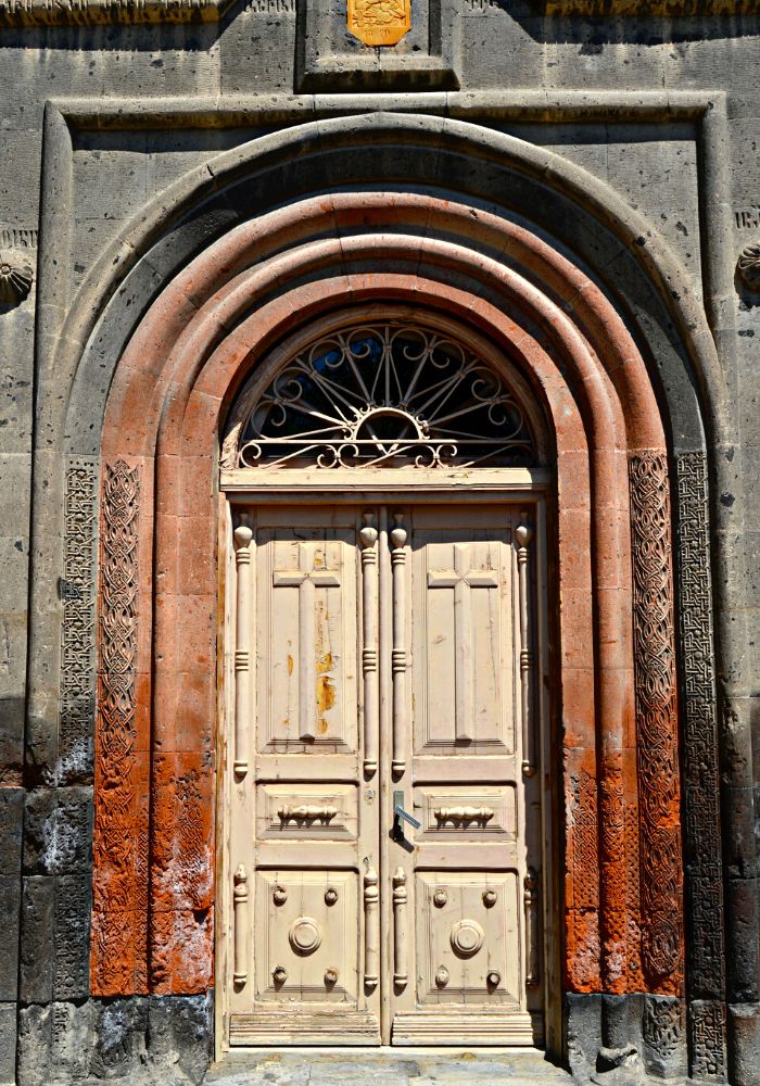 A white, black, and orange doorway in Gyumri, one of The Best Places to Visit in Armenia.