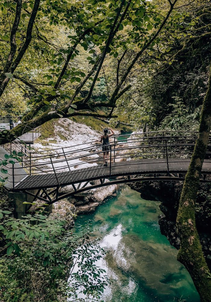 Monica on a bridge, overlooking blue water in Martvili Canyon, Georgia.