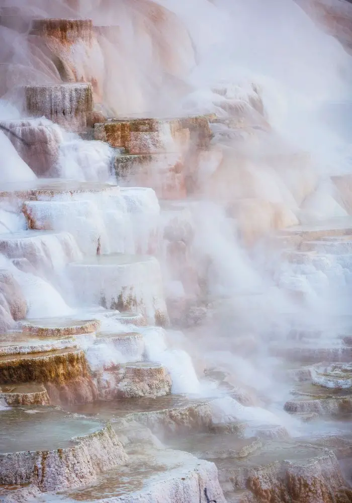 The travertine hot springs, a can't miss sight on your Salt Lake City to Yellowstone National Park Road Trip.